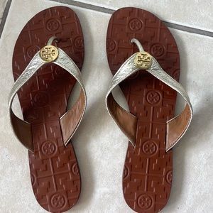 Tory Burch gold flip flops.